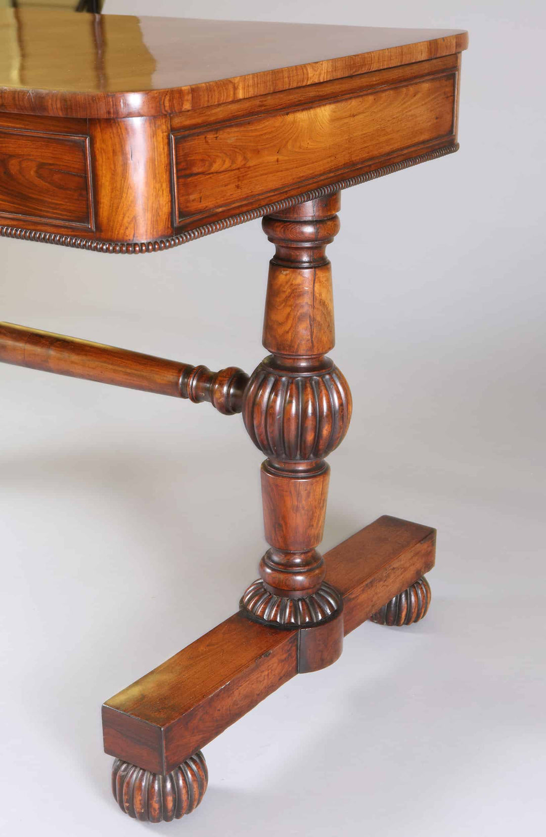 Close-up of the kingwood end support on the William IV Kingwood End Support Writing Table showing detailed turned stretcher.