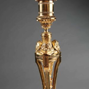 Pair of French Gilt Bronze Neo Classical Candlestick Table Lamps with intricate gilt details on white marble bases circa 1880.