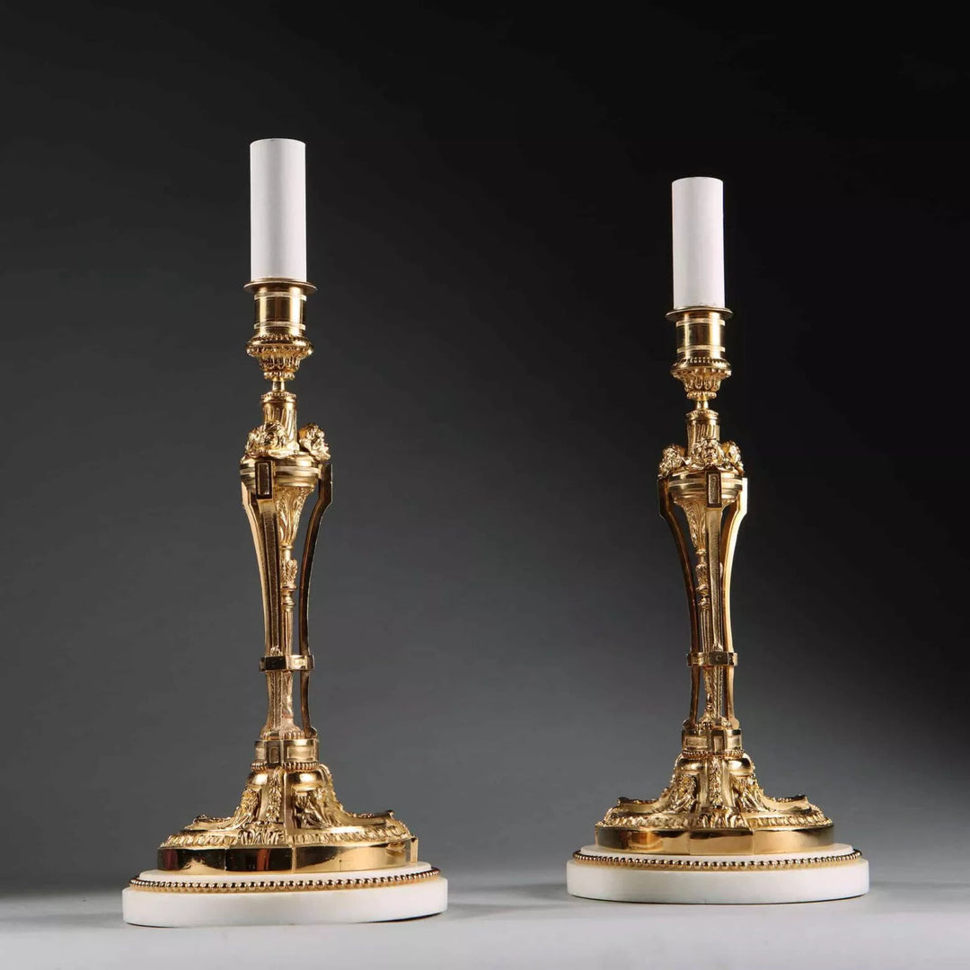 Pair of French Gilt Bronze Neo Classical Candlestick Table Lamps with white marble bases circa 1880, 30 cm tall.