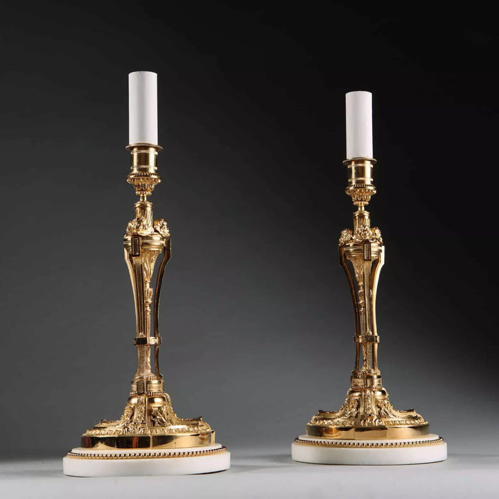 Pair of French Gilt Bronze Neo Classical Candlestick Table Lamps with white marble bases circa 1880, 30 cm tall.