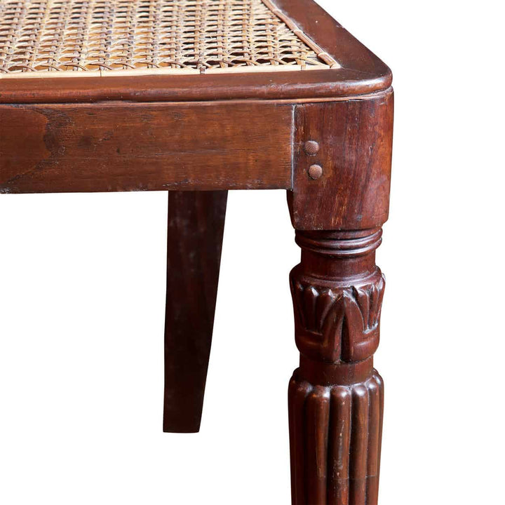 Close-up of carved hardwood leg and woven cane seat of South Indian 19th century side chair Collection EE30