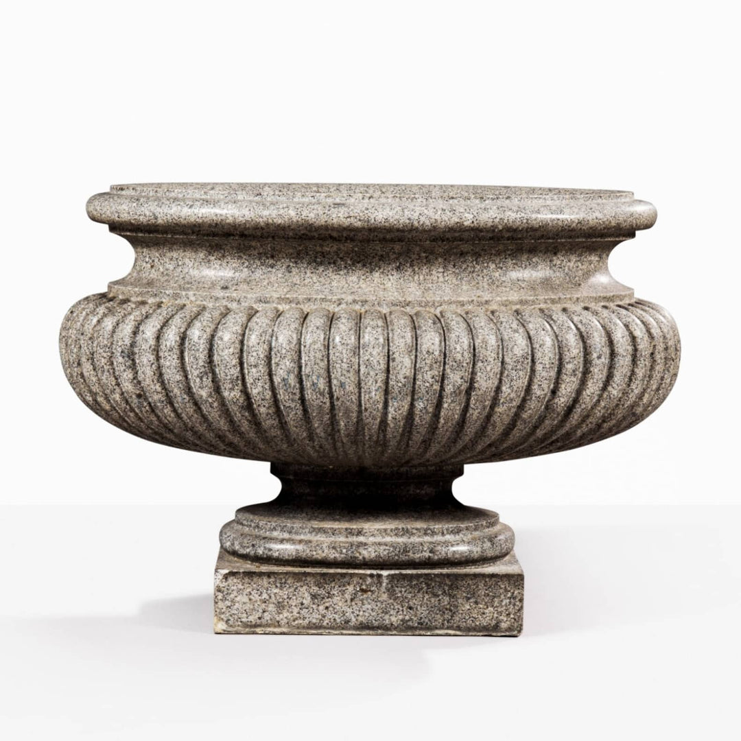 Large carved porphyritic granite gadrooned oval vase on stepped base by Collection EE20, circa 1800.