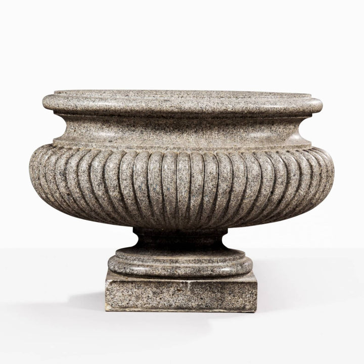 Large carved porphyritic granite gadrooned oval vase on stepped base by Collection EE20, circa 1800.