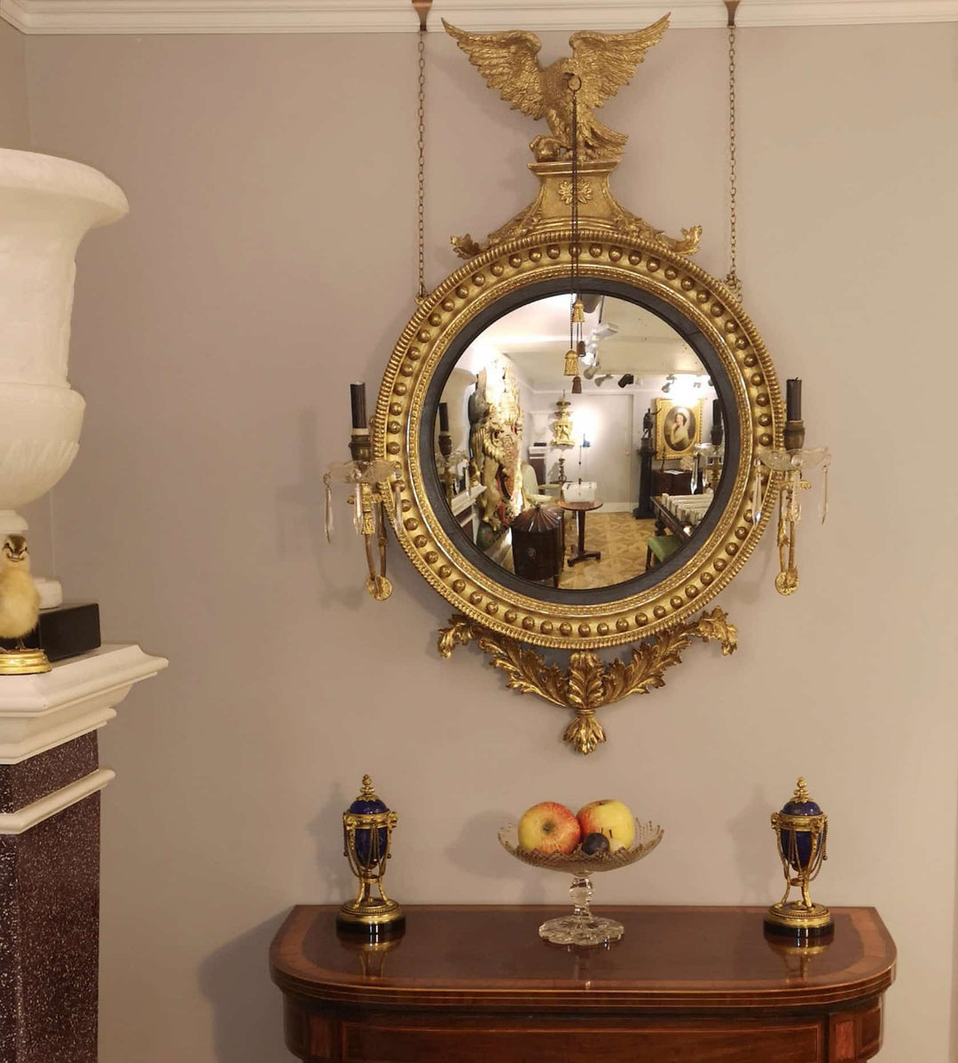 Fine English 19th Century Regency Convex Mirror with gilt frame, eagle crest, candle arms, and ebonised slip detailing.