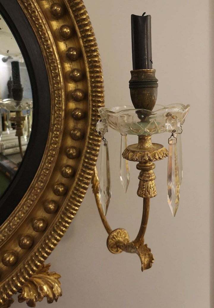 Fine English 19th Century Regency Convex Mirror with giltwood frame and ornate candle arm with glass drops.