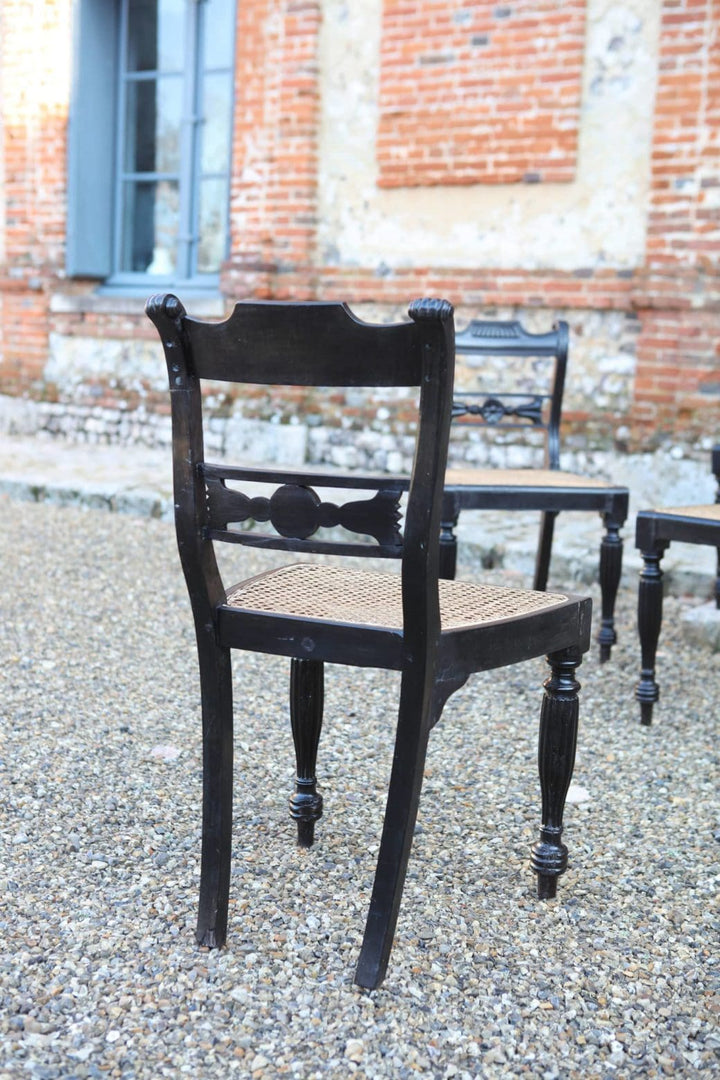 Set of six 19th century Anglo Indian ebony side chairs with caned seats by Collection EE30.