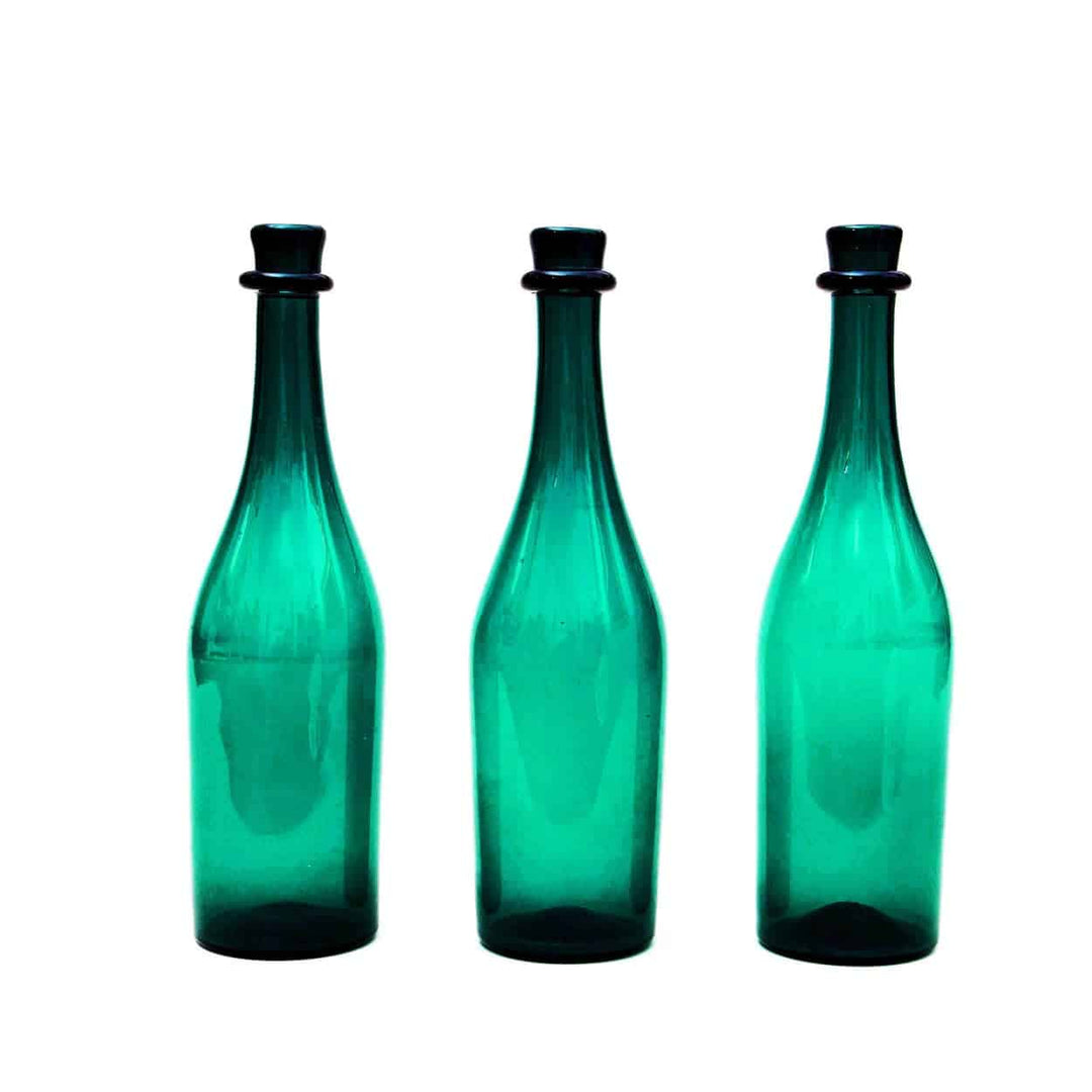 A Group Of Three Green Bottles