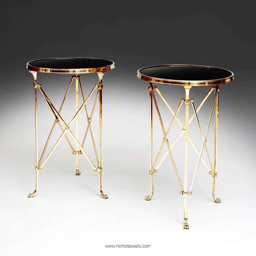 Pair of Mid-Century Roman End Tables with burnished brass legs, lion paw feet, and black Belgian marble tops.