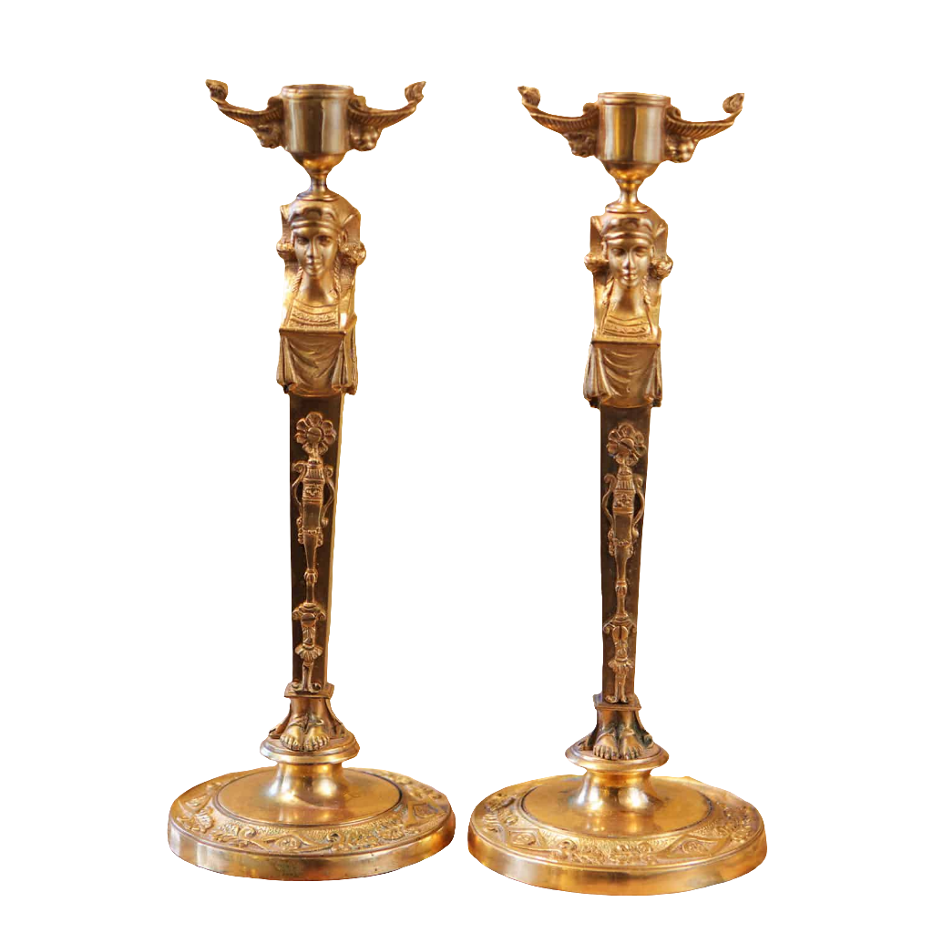 Pair Of Neo Egyptian Empire Gilt Bronze Candlesticks with female caryatid figures and lion mask nozzles, circa 1820.