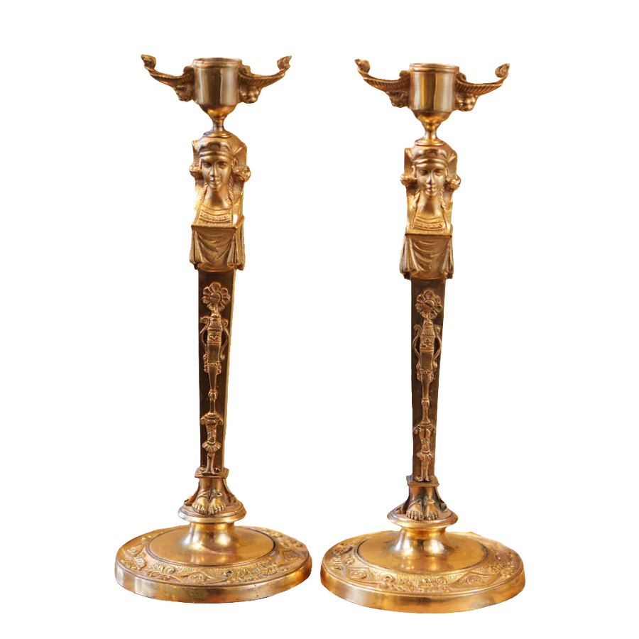 Pair Of Neo Egyptian Empire Gilt Bronze Candlesticks with female caryatid figures and lion mask nozzles, circa 1820.