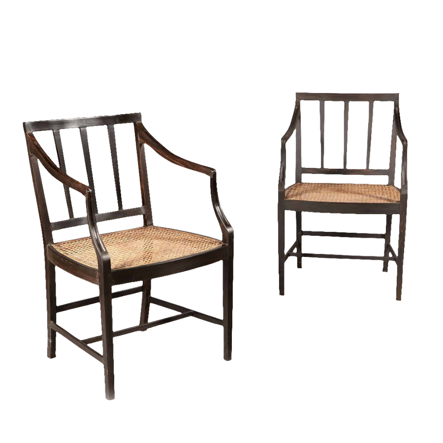 Two solid ebony Anglo Indian dining chairs with caned seats by Collection EE30, circa 2000 craftsmanship.