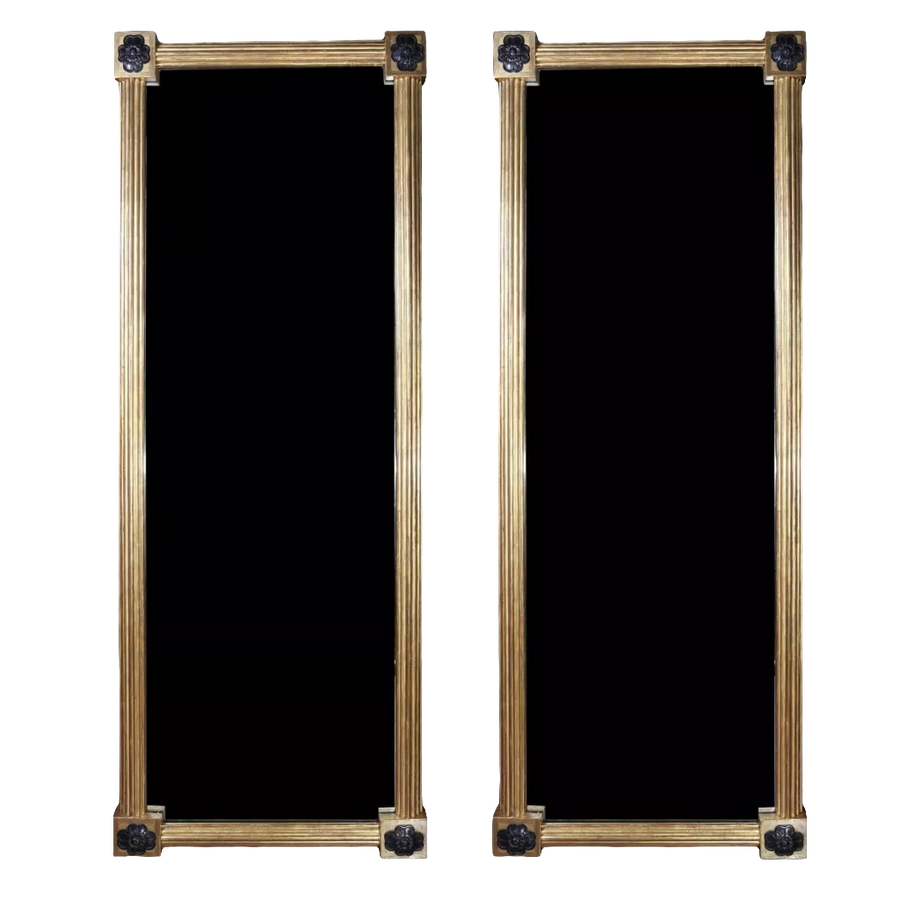 Pair of Tall Regency Giltwood Pier Mirrors with reeded frames and floral corner details, England circa 1850.