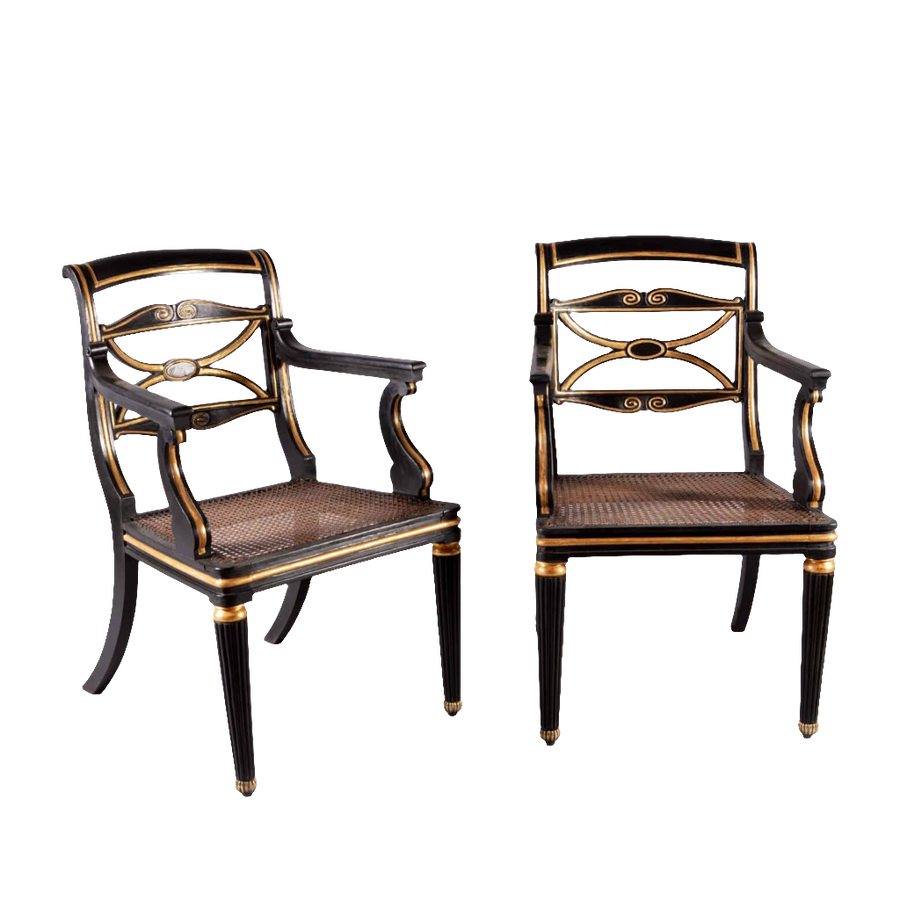 A pair of Regency parcel gilt armchairs with cane seats and brass feet from Collection TH20.