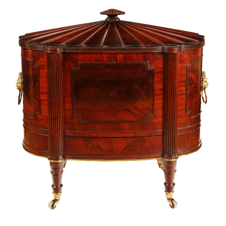 George III Cellarette Attributed To Gillows mahogany oval cabinet with hinged lid, brass cased legs, and lion mask handles.