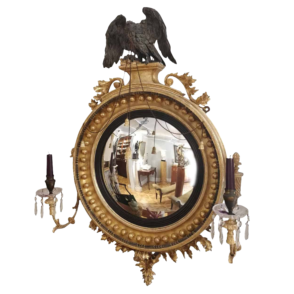 Regency Convex Mirror with a Black Eagle featuring gilt frame, crystal candle arms, and acanthus volutes, circa 1810.