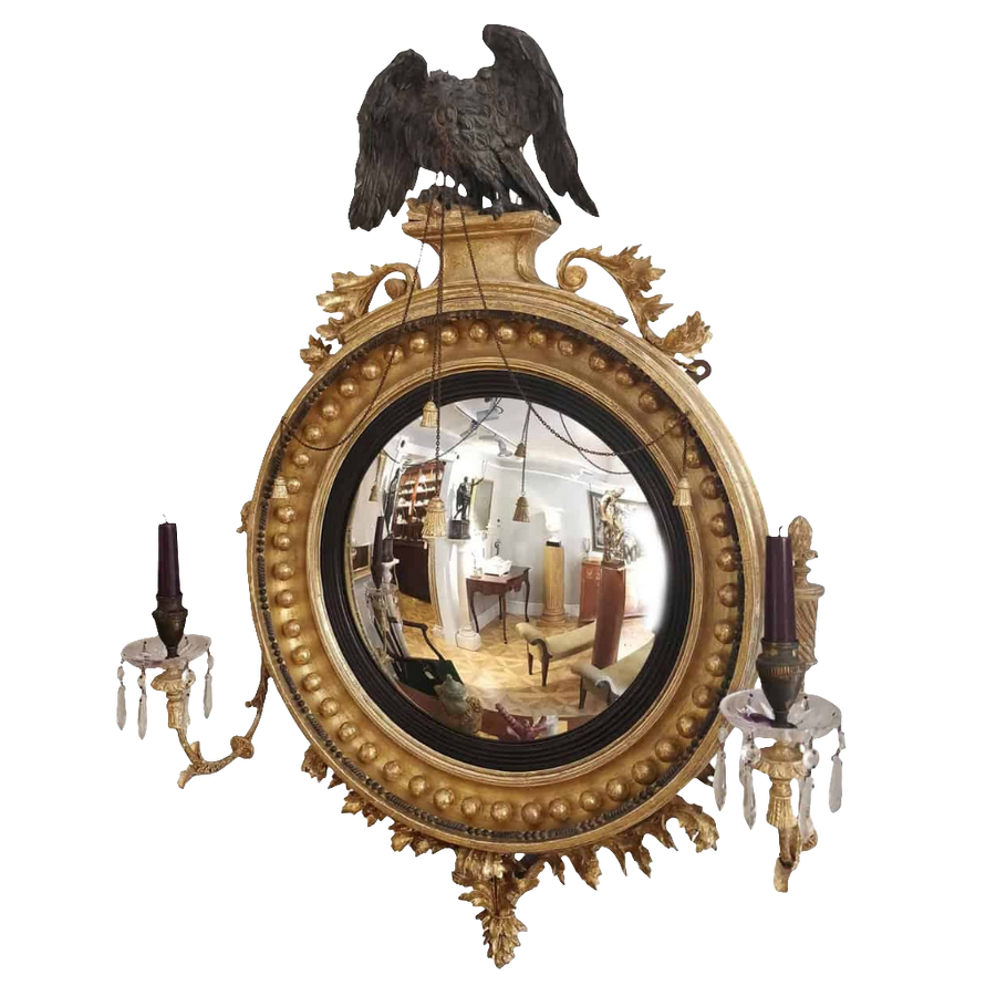 Regency Convex Mirror with a Black Eagle featuring gilt frame, crystal candle arms, and acanthus volutes, circa 1810.