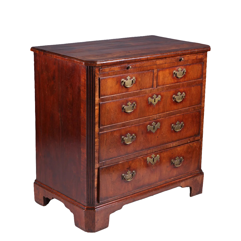 George I Walnut Chest of Drawers with five graduated drawers, brass handles, fluted corners, and bracket feet, circa 1715.