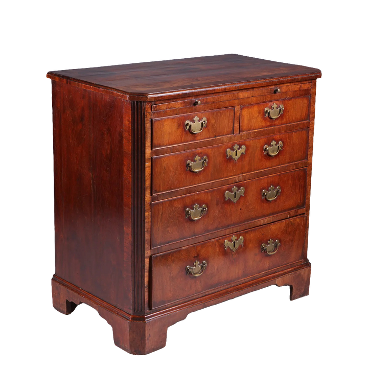 George I Walnut Chest of Drawers with five graduated drawers, brass handles, fluted corners, and bracket feet, circa 1715.