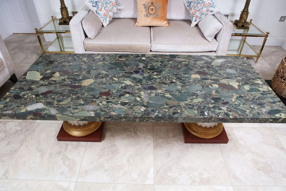 Large Breccia D’Egypt Green Marble Coffee Table with green marble top and gilt column bases in living room setting.