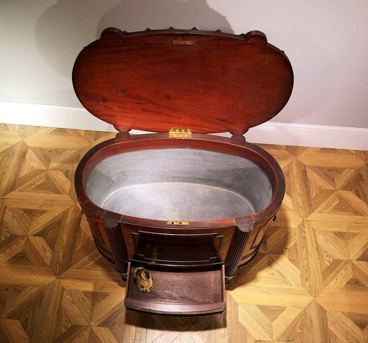 George III Cellarette Attributed To Gillows mahogany with hinged lid, lead-lined interior, tapered fluted legs, brass casters.