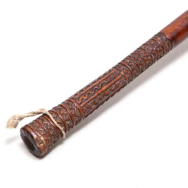 Lobed Tribal Fijian Ula Throwing Club handle showing intricate zigzag carvings on dark wood with cord wrap detail.