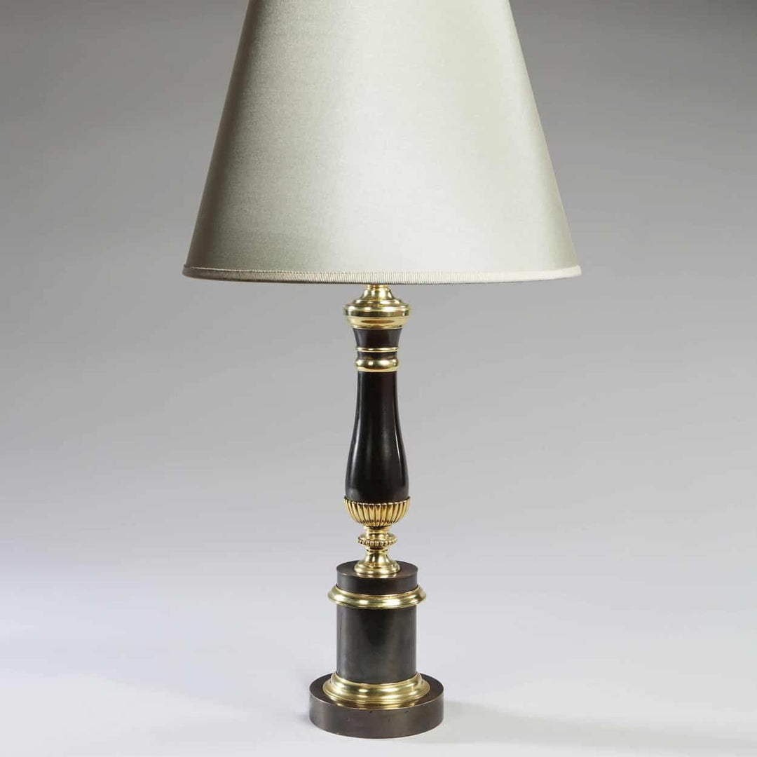 Vintage Column Table Lamps Gunmetal & Brass Maison Charles elegant table lamp with brass accents and grey finish on stepped plinth.