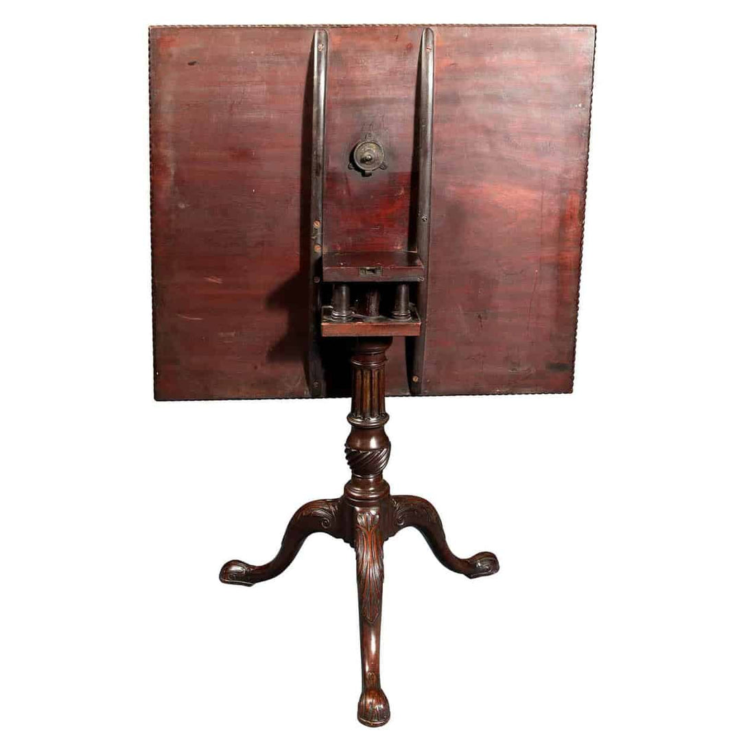 GEORGE III MAHOGANY RECTANGULAR TRIPOD TABLE with carved top, birdcage tilt, fluted column, and cabriole legs.