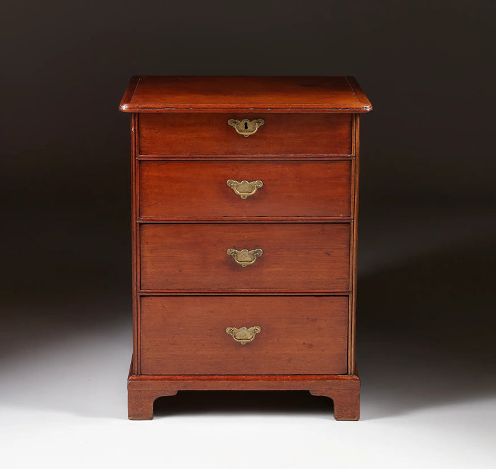 George I Pedestal Chest of Drawers in mahogany with four brass-handled drawers on ogee bracket feet, circa 1725.