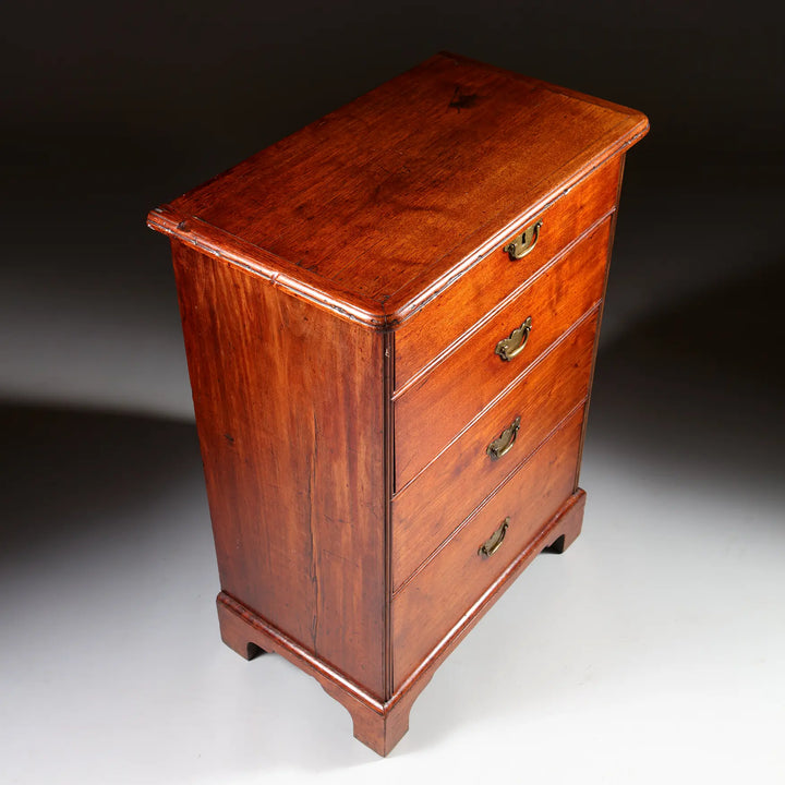 George I Pedestal Chest of Drawers in mahogany with four brass-handled drawers and ogee bracket feet, circa 1725.