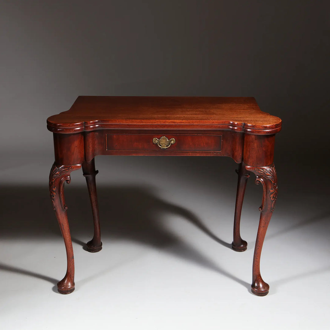 George II Mahogany Card Table with shaped top, single drawer, cabriole legs, and acanthus detailing, circa 1735 England.