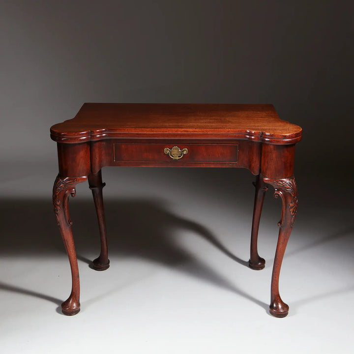 George II Mahogany Card Table with shaped top, single drawer, cabriole legs, and acanthus detailing, circa 1735 England.