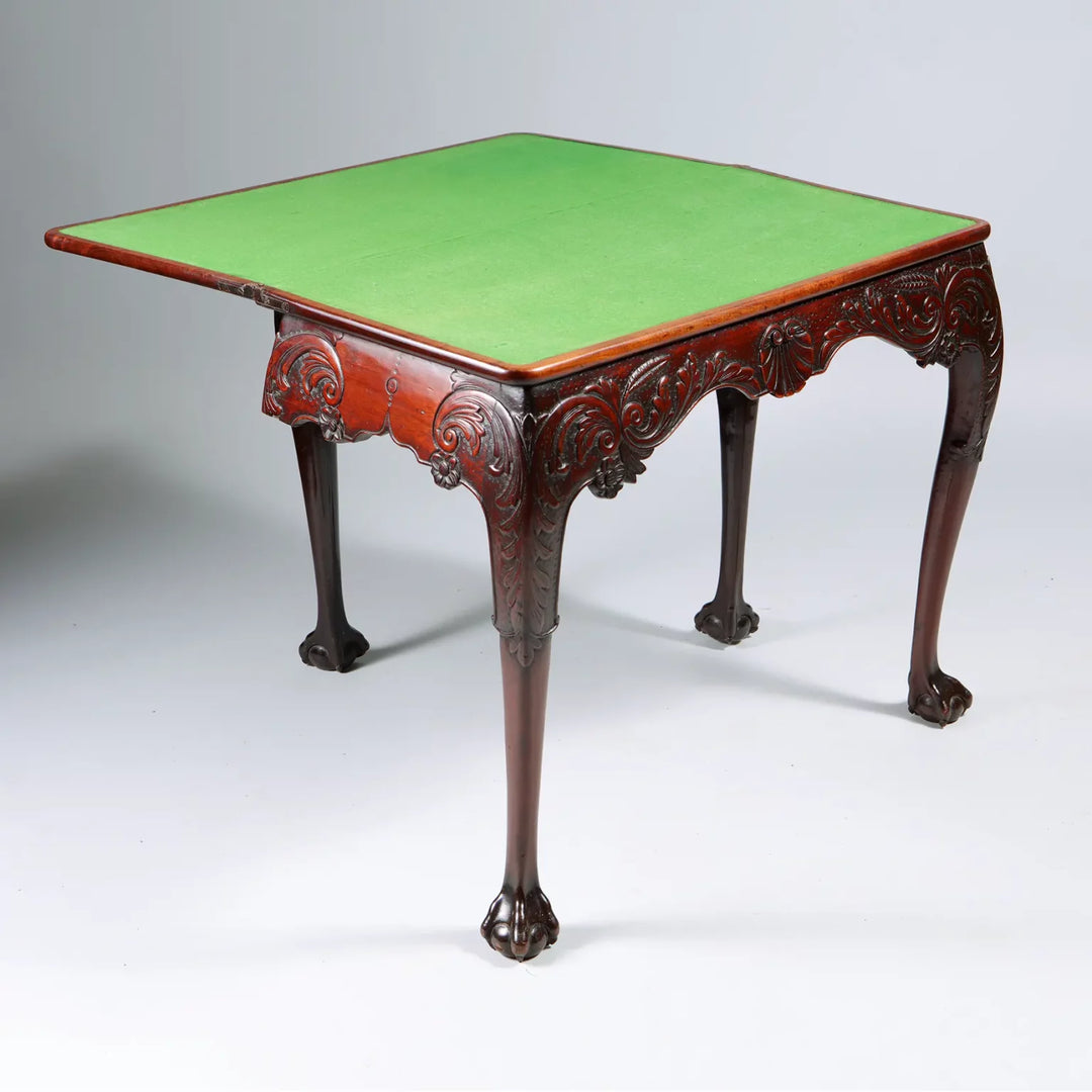 George II Irish Mahogany Card Table with carved frieze, cabriole legs, ball and claw feet, and green baize top circa 1740.