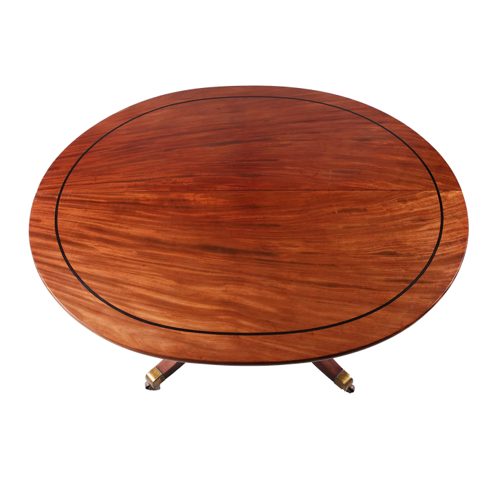 Extending Oval Dining Table in the Manner of George Bullock with mahogany top and ebony stringing on pedestal base.