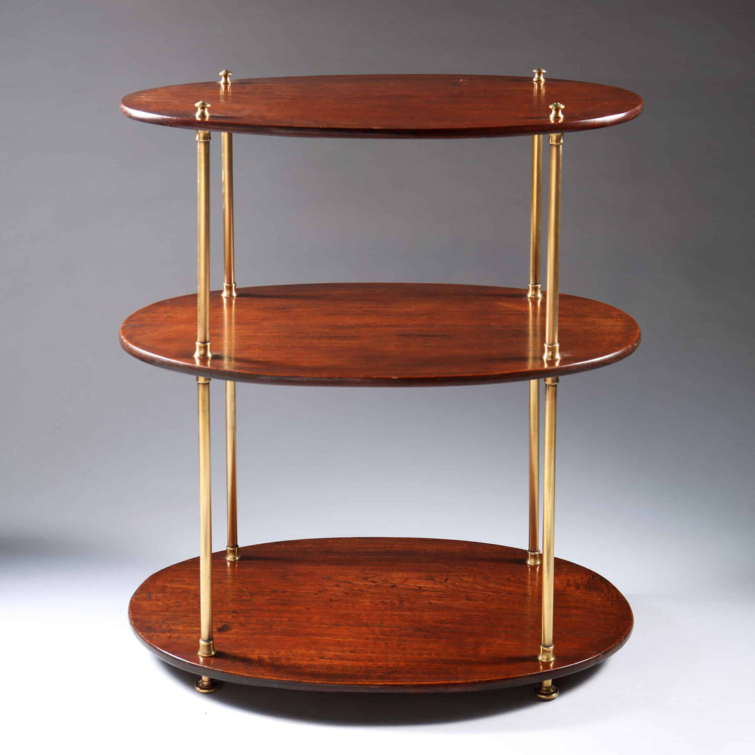 An Edwardian brass and wood oval three tier etagere