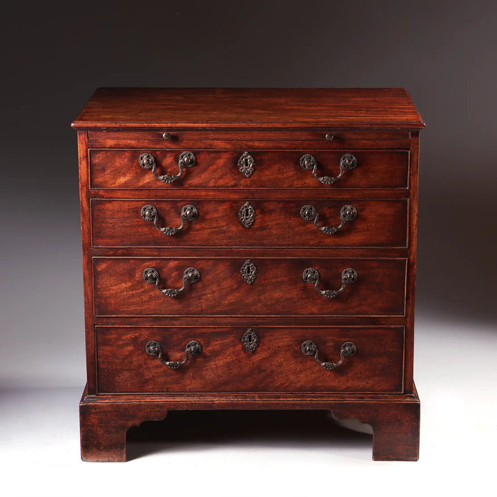 GEORGE II MAHOGANY CHEST OF DRAWERS mid 18th century with oxidised handles, brushing slide, and bracket feet, England circa 1740-1750