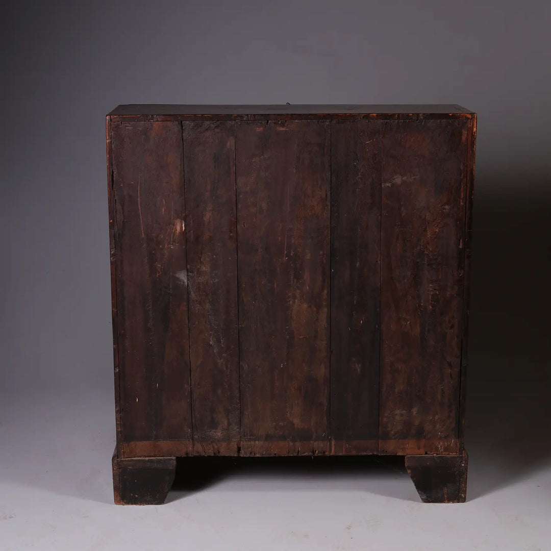GEORGE I BURR WALNUT BUREAU CHEST showing aged wood back panel and solid block feet in dark finish