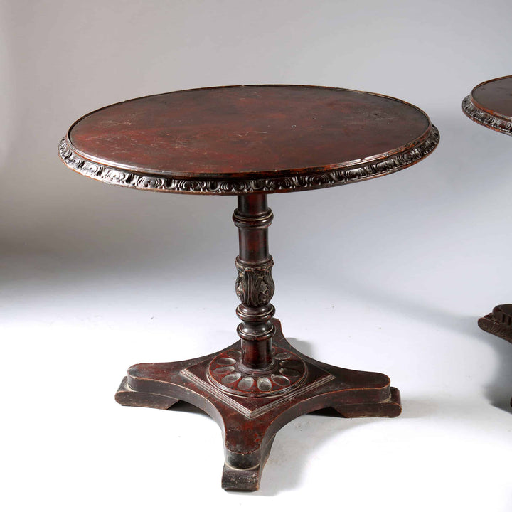 Matched Pair of Indian Circular End Tables with carved circular tops and ornate column bases on four scroll feet circa 1900.