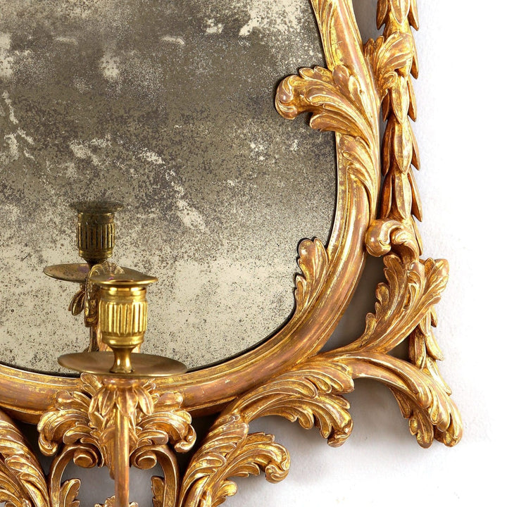 Georgian giltwood girandole mirror with carved acanthus leaves and a single candle arm antique English circa 1780.