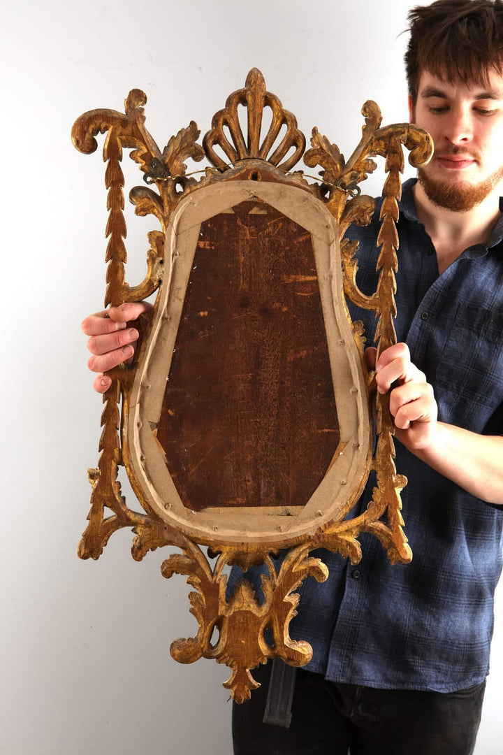 Georgian giltwood girandole mirror with carved anthemion, acanthus leaves, and candle arm, circa 1780 British Isles England.