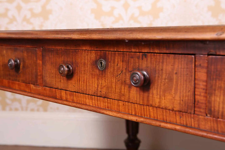 Regency Fiddleback Mahogany Partners Writing Table with turned wooden pulls and carved legs on brass castors circa 1815 England.