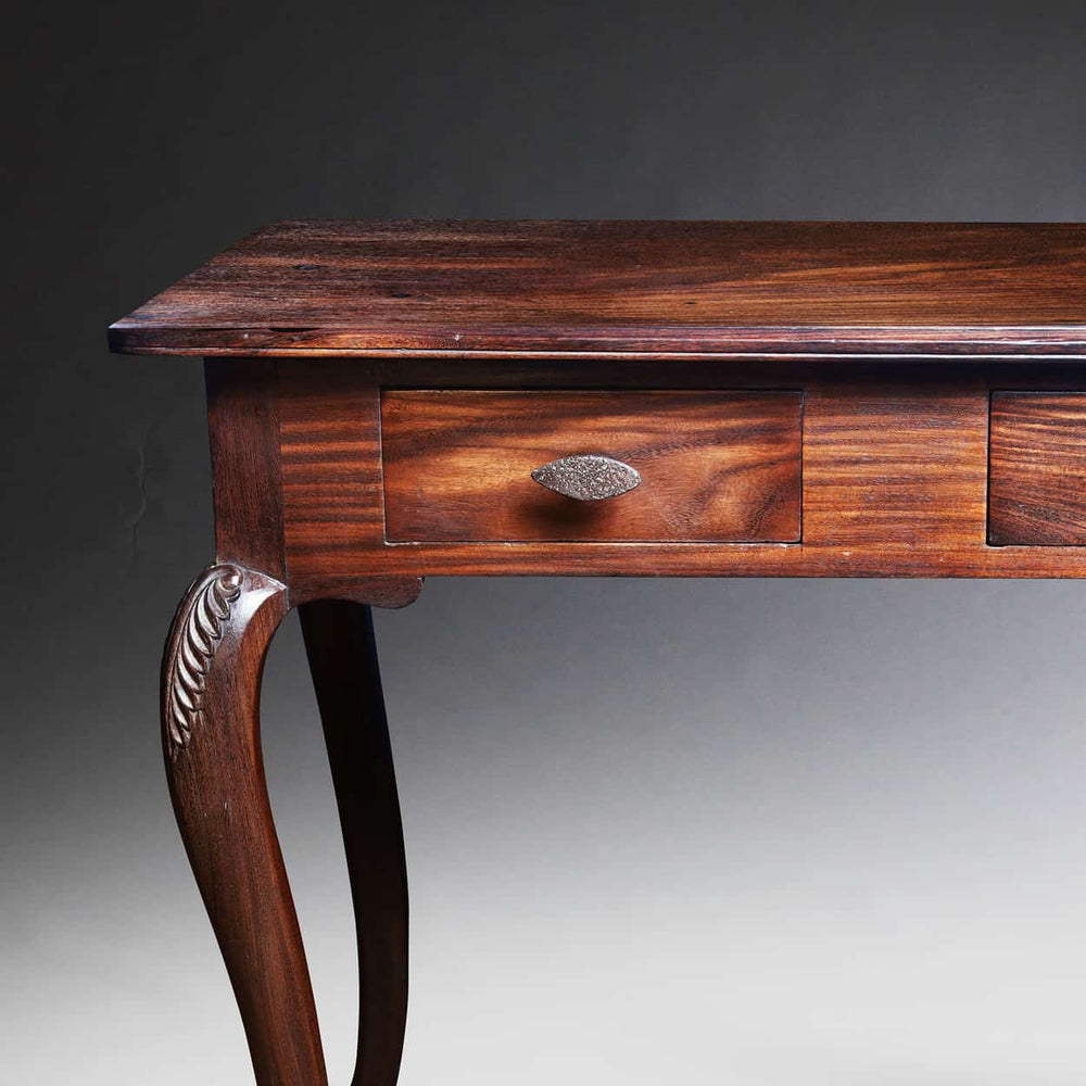 Ceylonese Writing Table with single drawer, carved cabriole legs, rich wood grain, and polished finish.