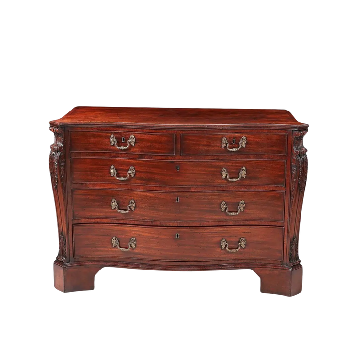 AN IMPORTANT GEORGE III MAHOGANY COMMODE Attributed to William Gomm with serpentine top and gilt rococo handles.