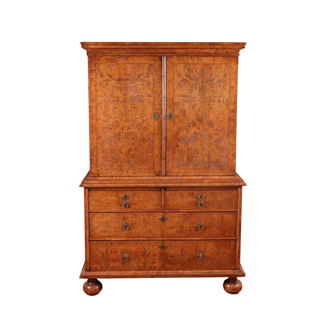 George I Burr Walnut Chest on Chest with bookmatched burr walnut doors and multiple drawers on turned bun feet.