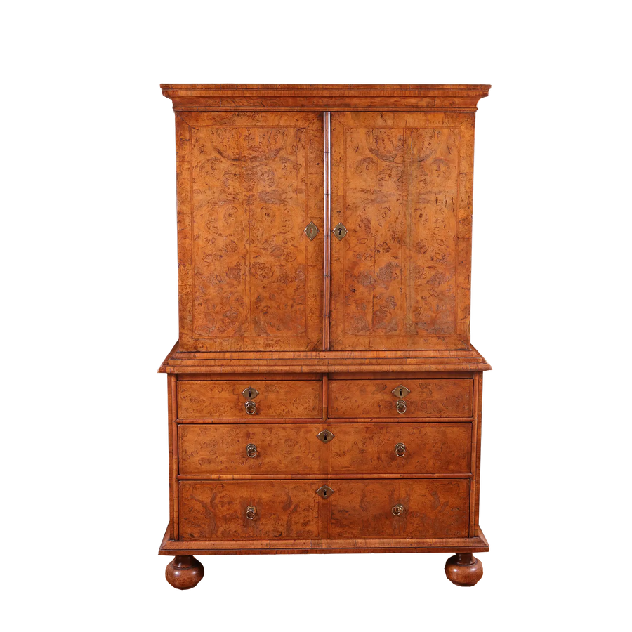 George I Burr Walnut Chest on Chest with bookmatched burr walnut doors and multiple drawers on turned bun feet.