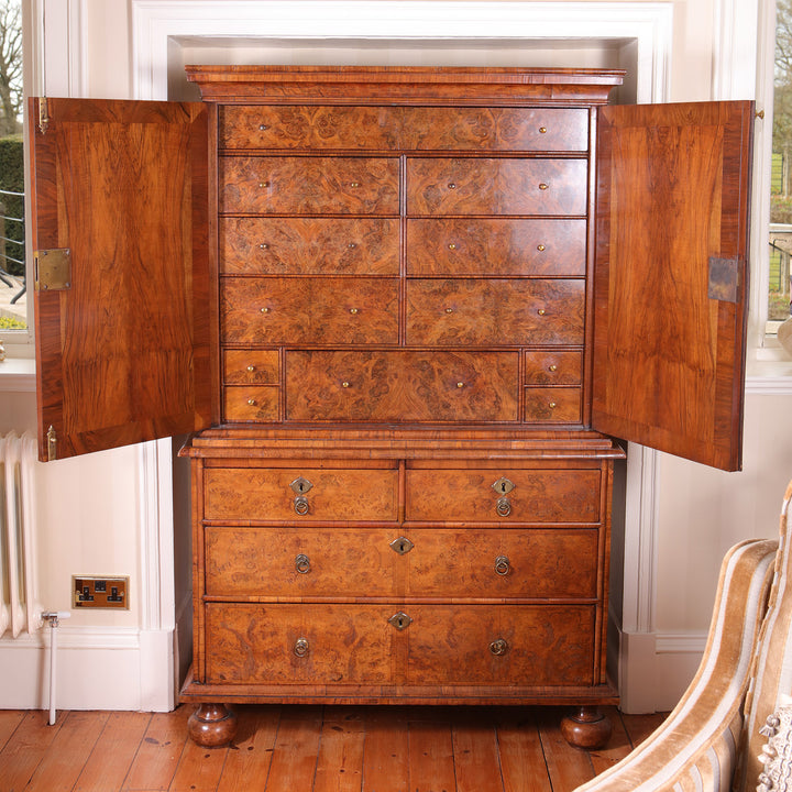 George I Burr Walnut Chest on Chest with upper cupboard doors and multiple drawers, early 18th century design.
