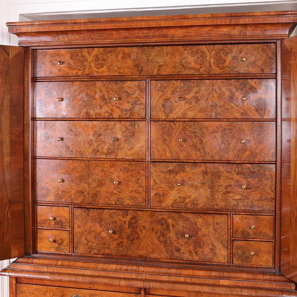 George I Burr Walnut Chest on Chest with bookmatched veneer and multiple fitted drawers, circa 1720 British Isles.