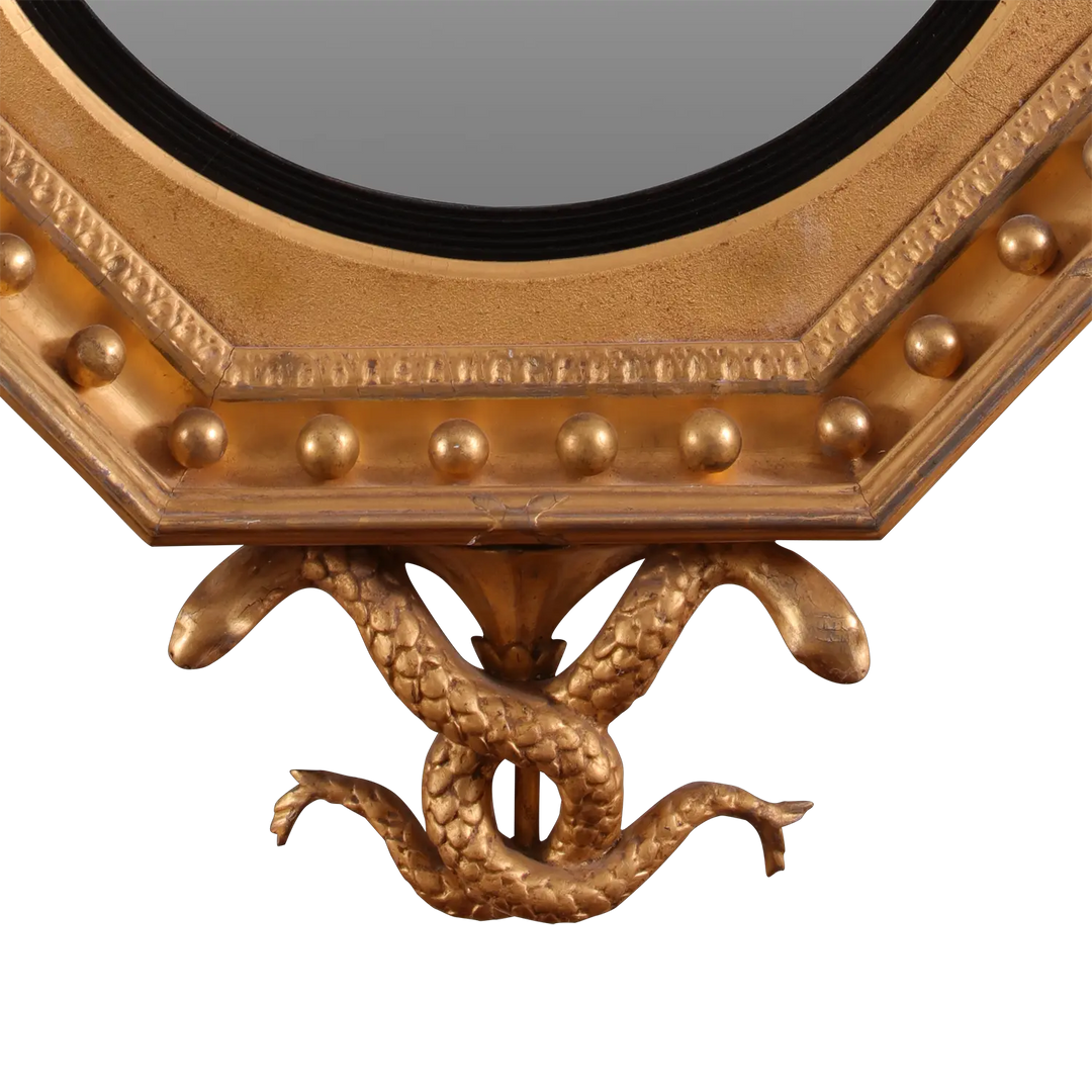 Rare Early 19th Century Regency Octagonal Convex Mirror with giltwood frame and intertwined serpents base detail.