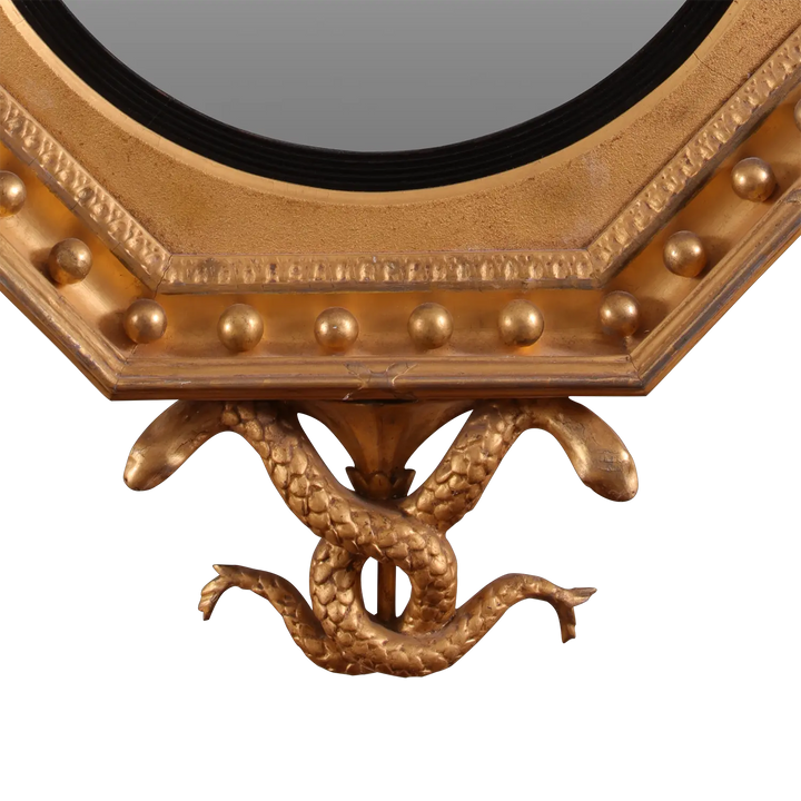 Rare Early 19th Century Regency Octagonal Convex Mirror with giltwood frame and intertwined serpents base detail.