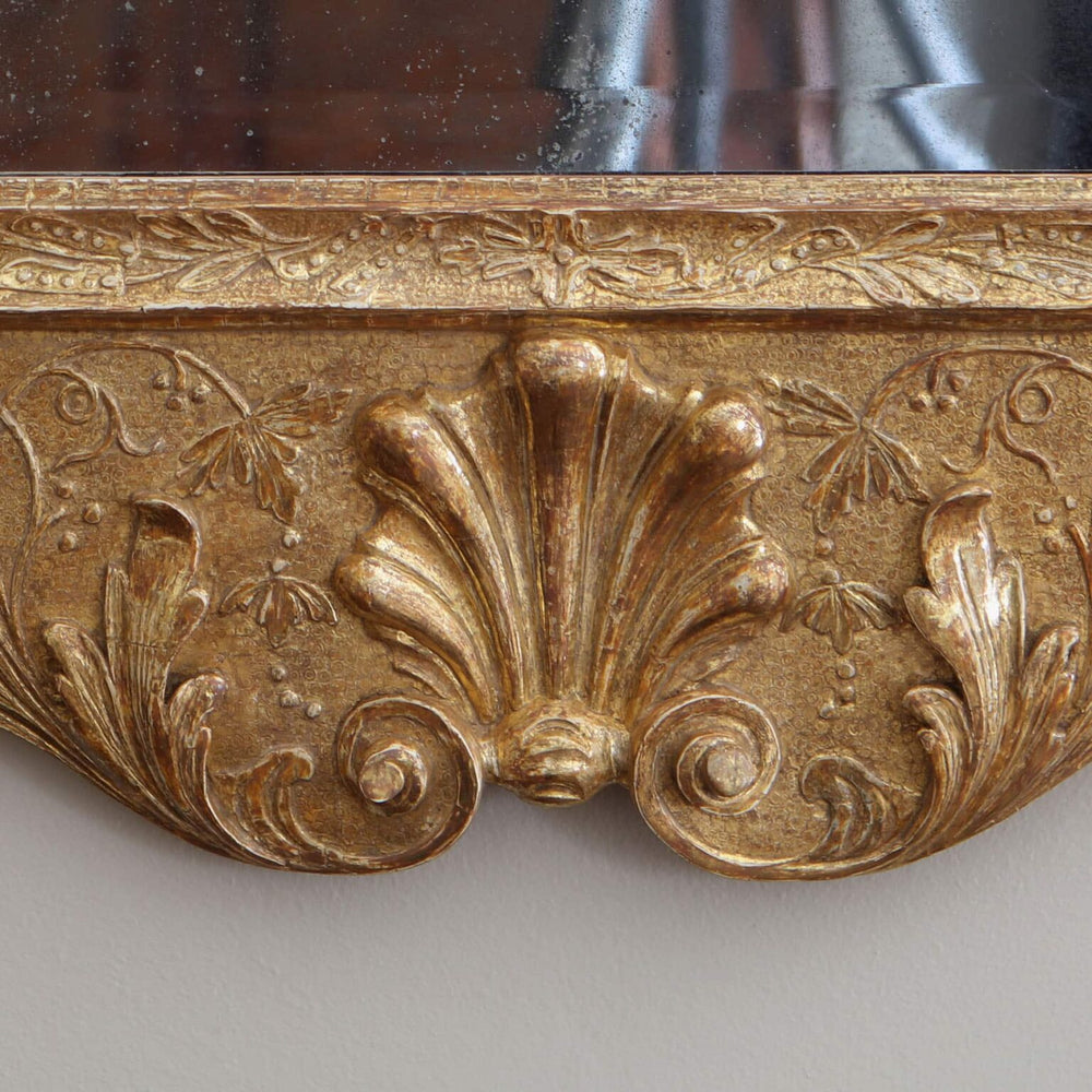 George II gesso Girandole Wall Mirror with intricate gilt gesso foliage carvings and shaped moulded frame detail.