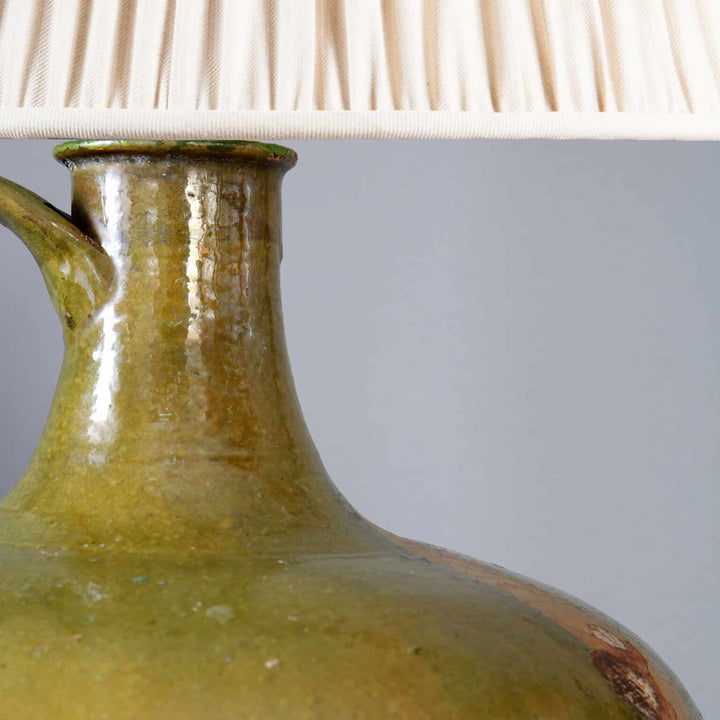 Large Green Glazed jar now mounted as a Table Lamp with cream pleated shade in close-up view.